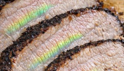 I slow cooked a pork roast for 8 hours, but when I sliced it, I saw this weird shiny green and rainbow reflection on the meat fibers. It looks like gasoline on water. Did the meat go bad?